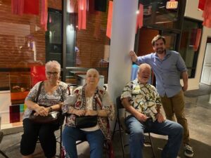 Billy Brookshire and program coordinator, Than Niles pose with guests from the event